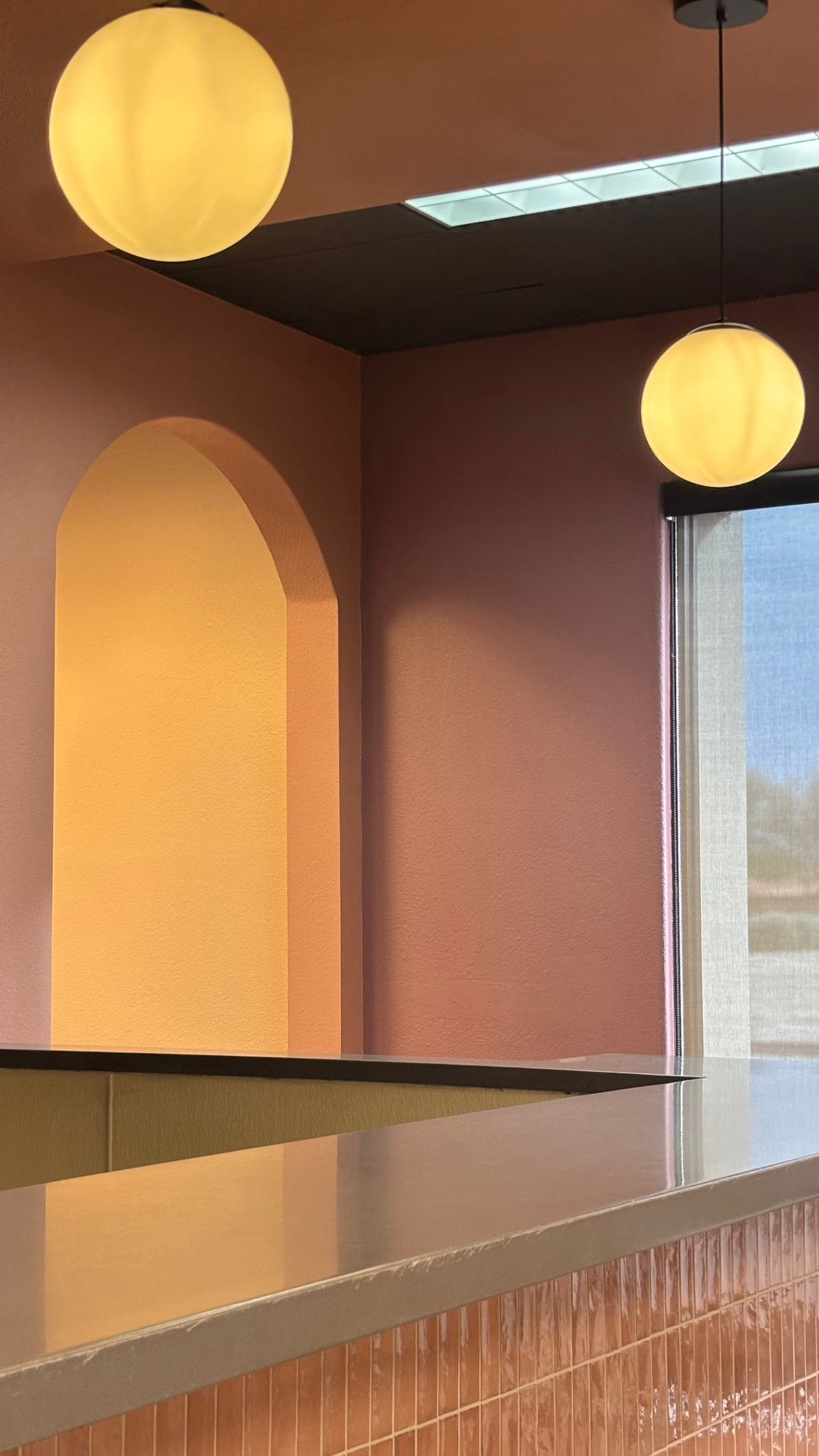 The Casa de Silvia counter, with the arched alcove and pendant lights above it