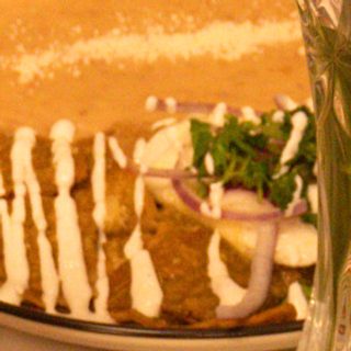 Huevos rancheros tostada with over-medium eggs on crisp tortillas